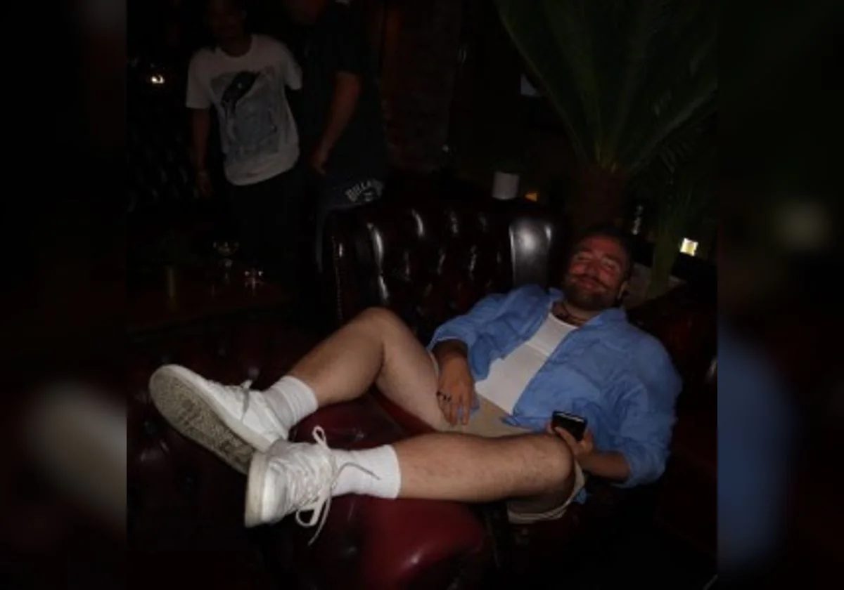 Blush’ko seated in a relaxed lounge portrait wearing a light blue shirt