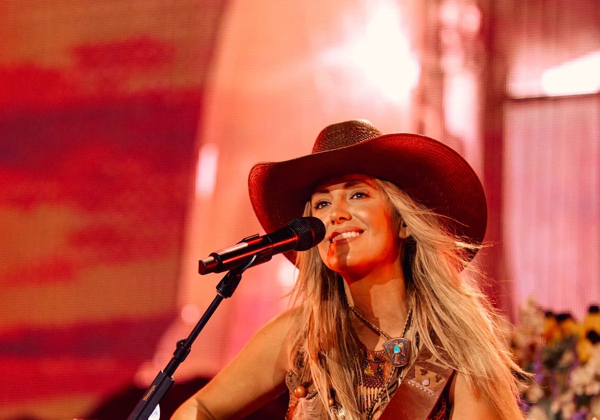 Lainey Wilson performing live on stage in Nashville