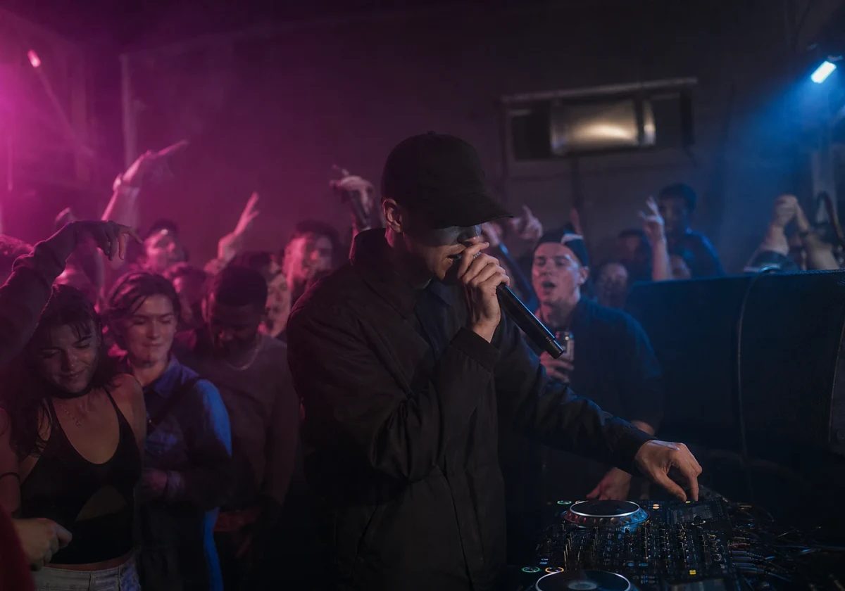 Anonymous 2-step garage performer singing beside decks in a small UK club