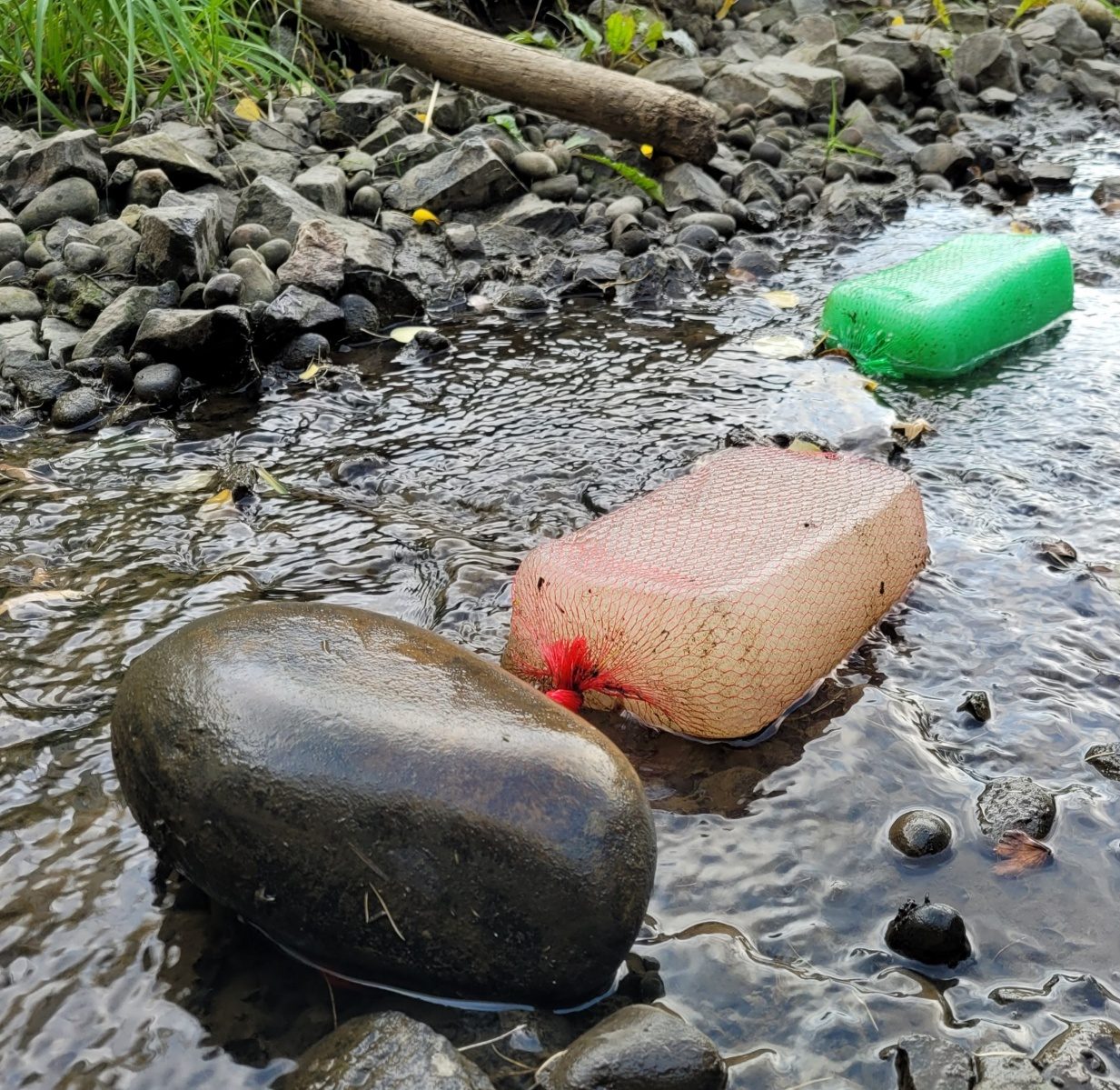 Gel Flocculant block in a mesh bag placed in a rocky stream