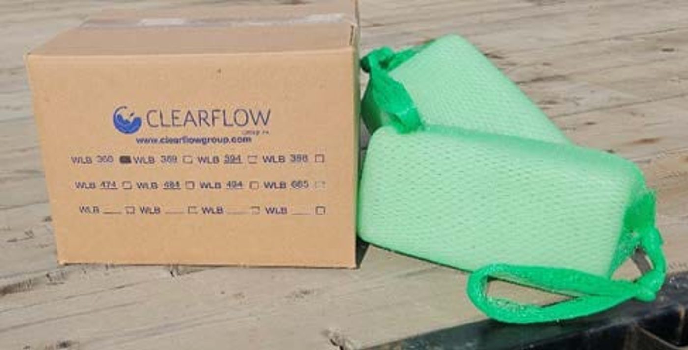 Green Gel Floc blocks in mesh sleeves beside a Clearflow shipping box