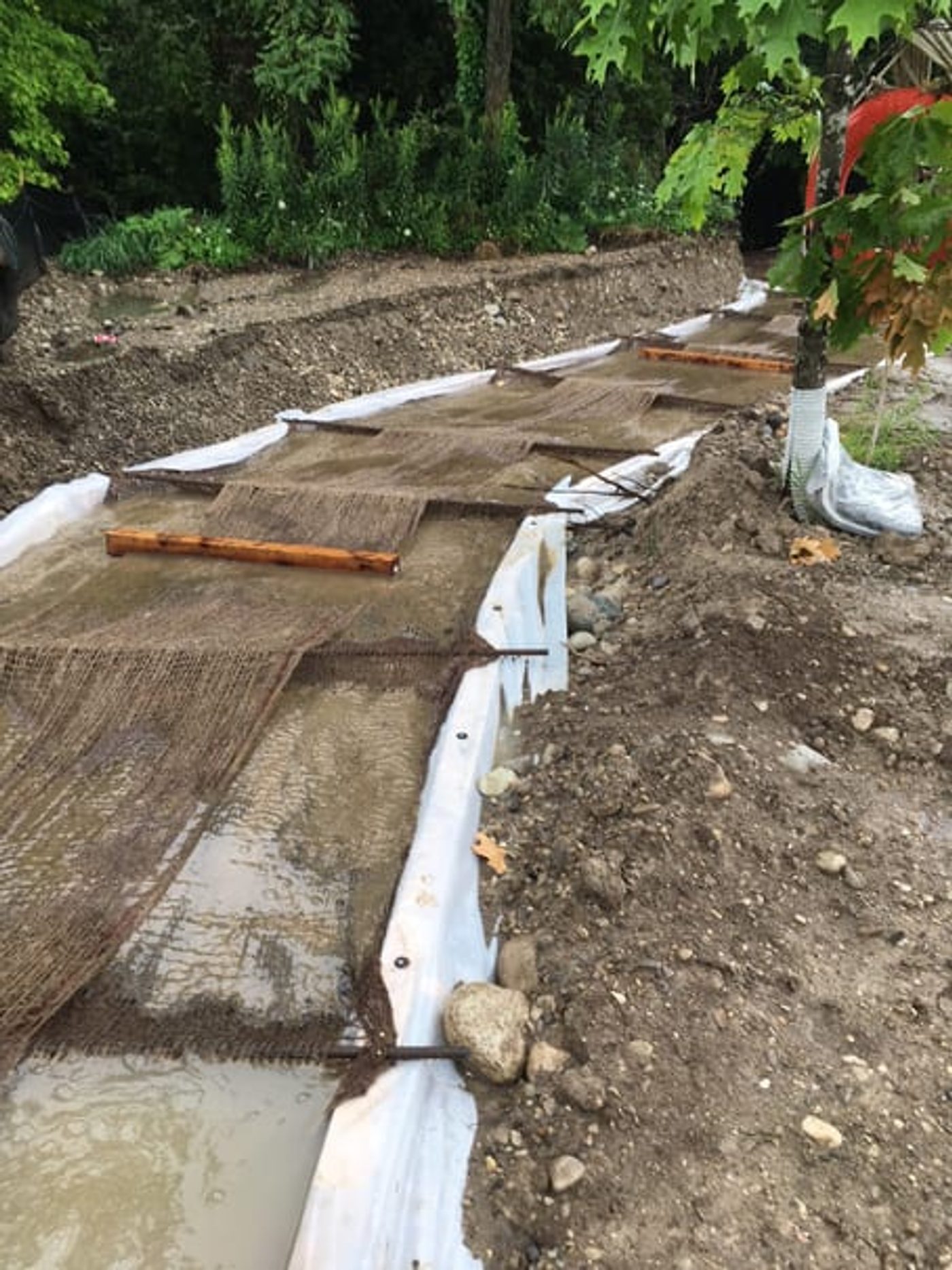 Constructed ditch lined with Clearflow treated jute capturing solids from the treated flow