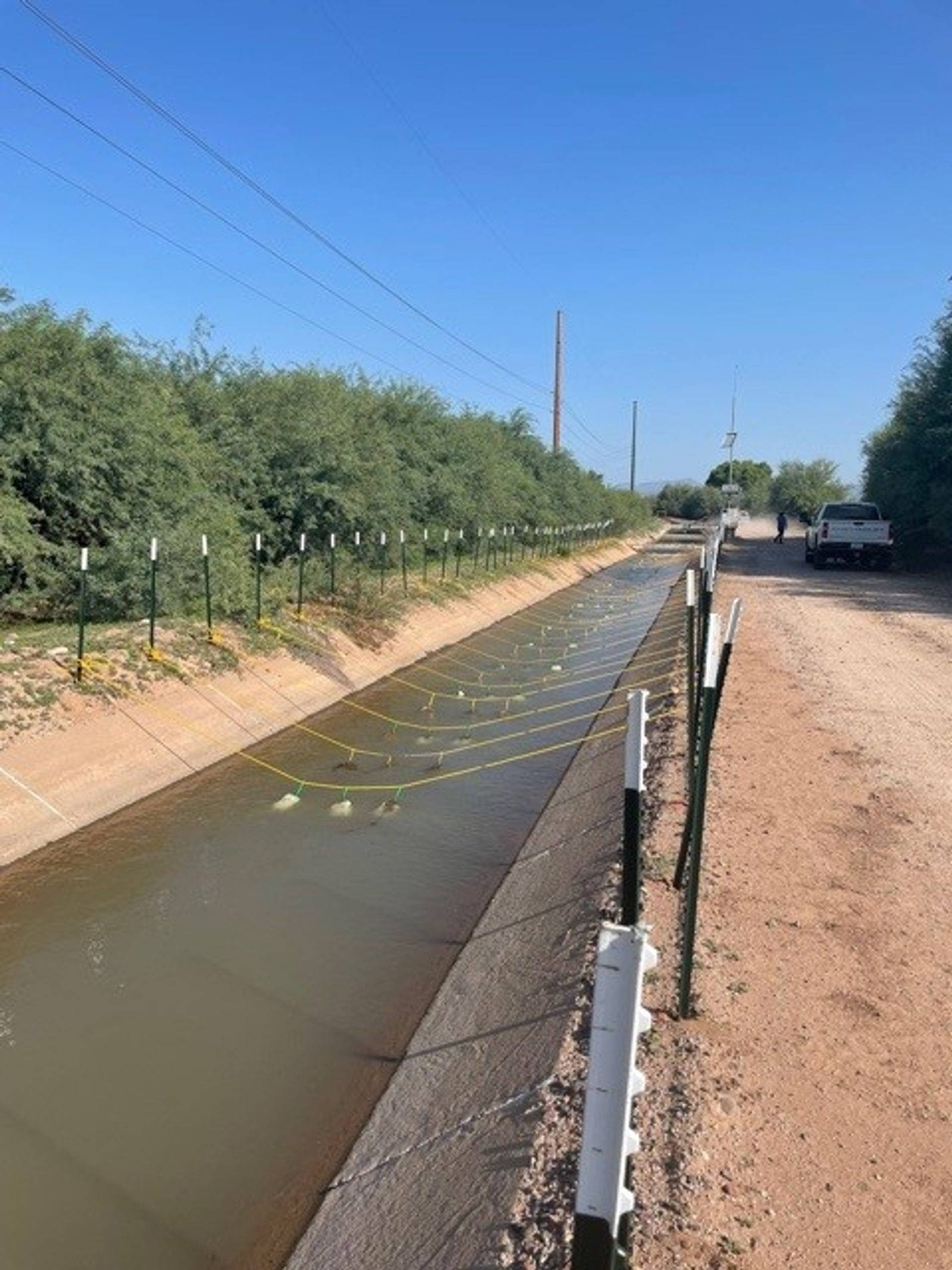 Gel Flocculant bags suspended across an open drainage canal