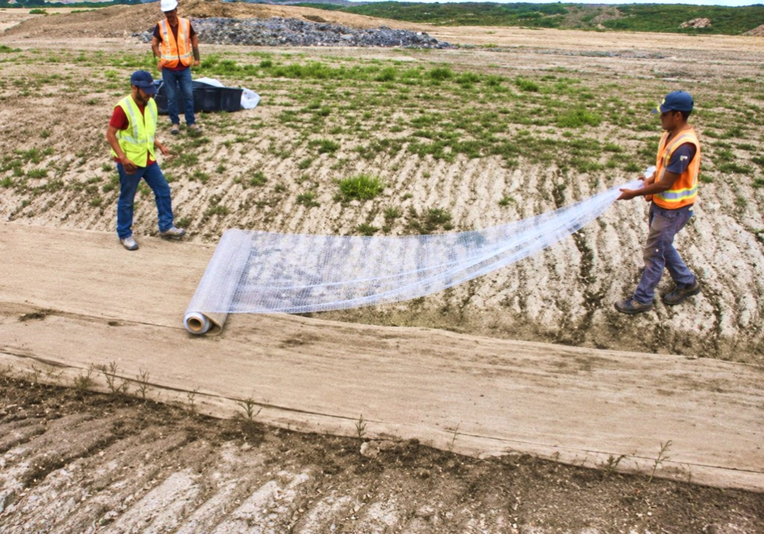 Crew installing Clearflow treated fabric on a water polishing site