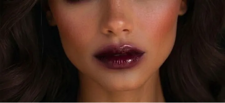 Close-up of glossy diffused wine lips with deep berry lipstick, soft blurred edges, and high-shine finish for a Vamp Romantic makeup look.