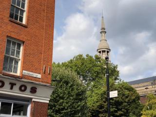 Competing borough signage on Boundary Street, Shoreditch. St Leonard's church visible in the background.