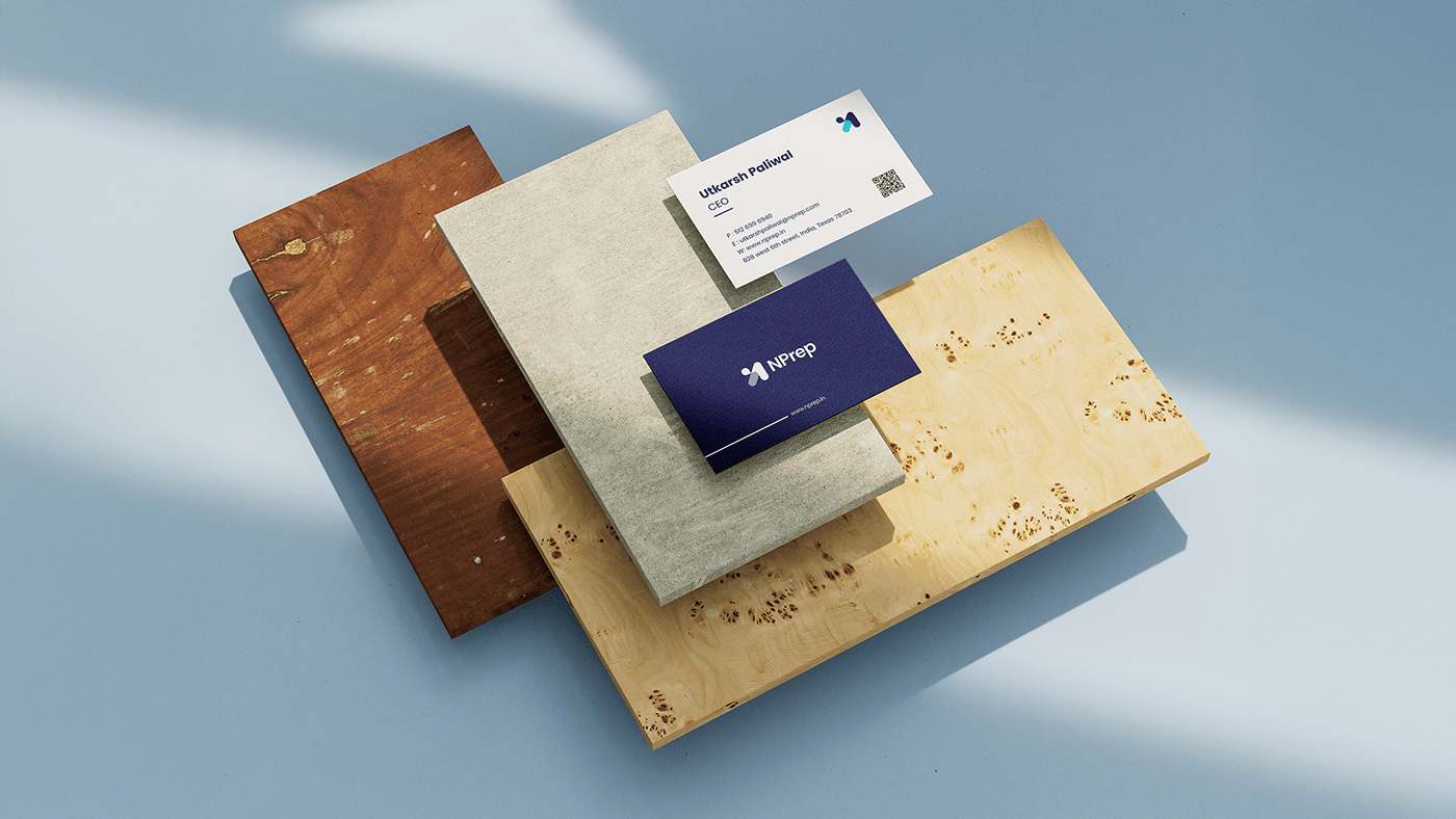 NPrep business cards in midnight blue on wooden and stone surfaces