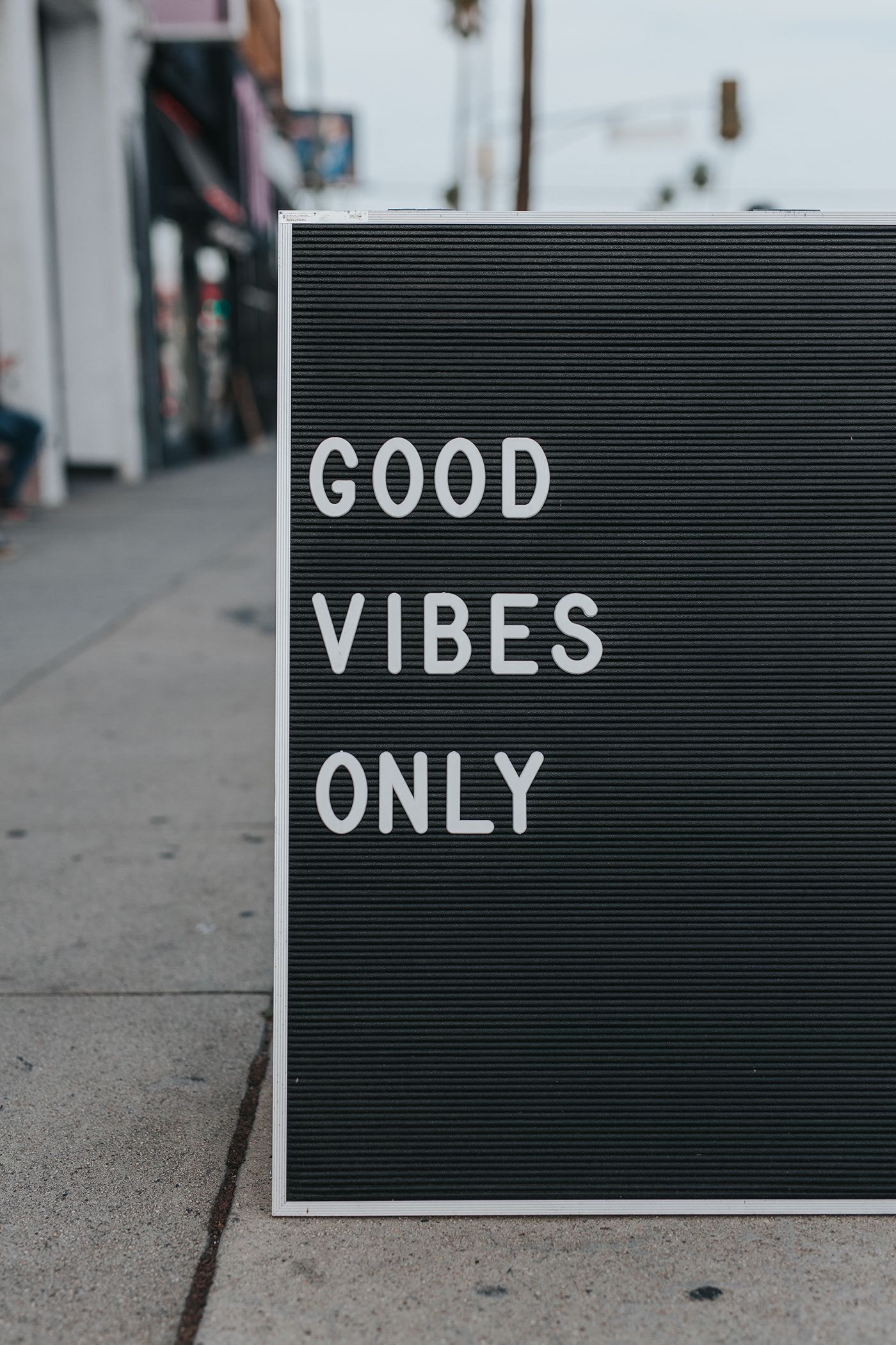 Mood reference photograph of a chalkboard sign reading Good vibes only