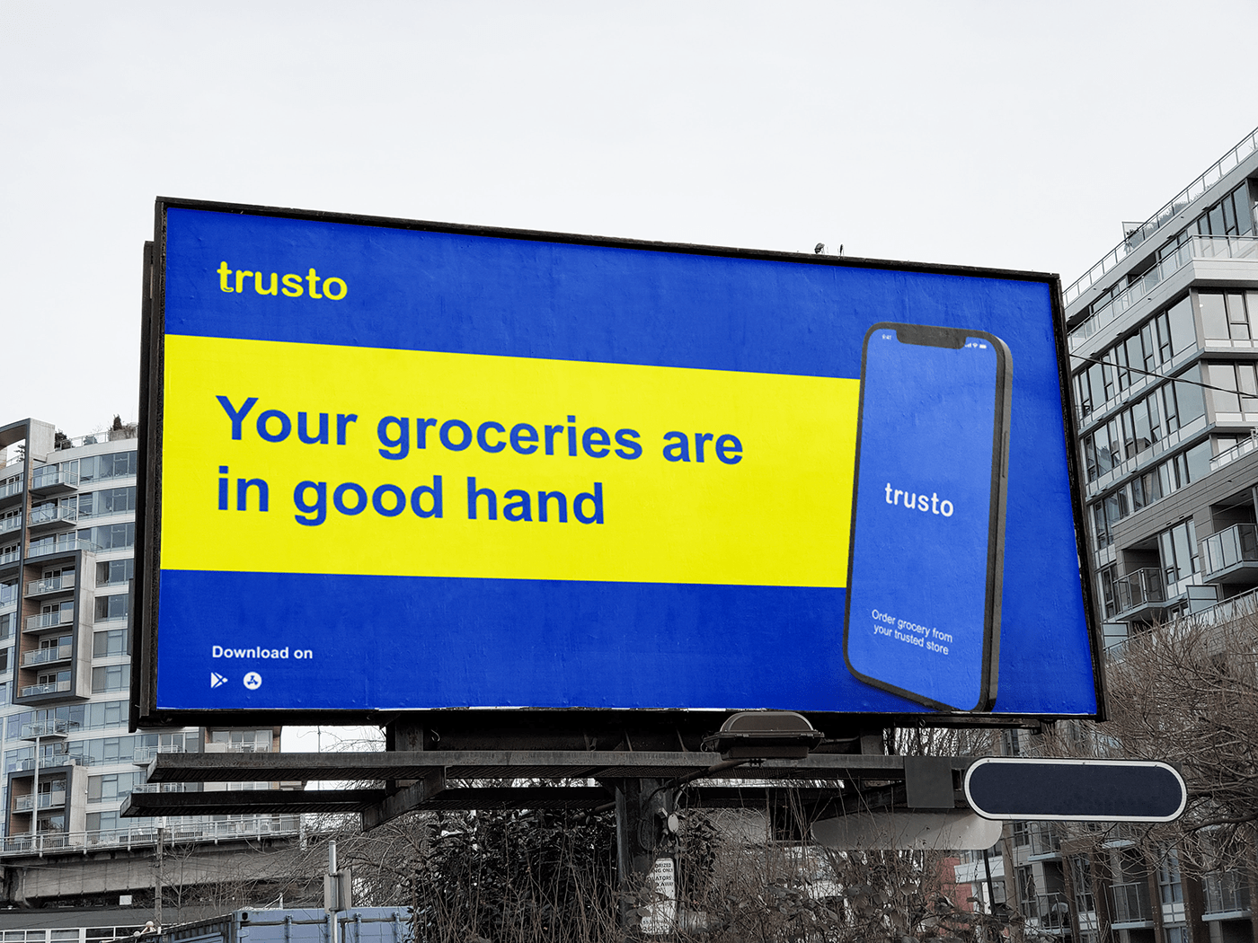 Trusto billboard in blue and yellow with the line Your groceries are in good hand
