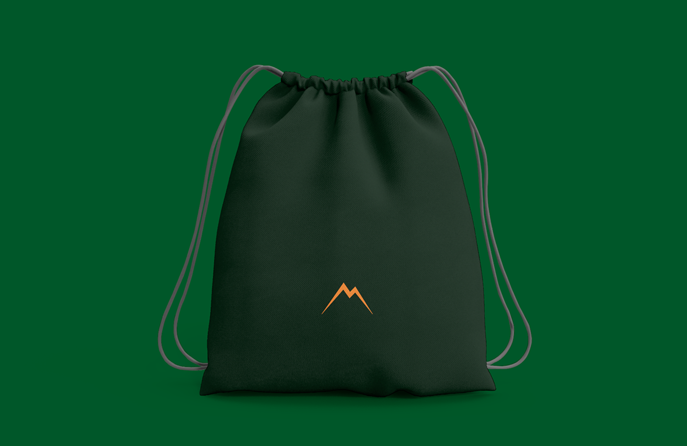 Dark green drawstring bag with the orange Travel Mitan mountain mark