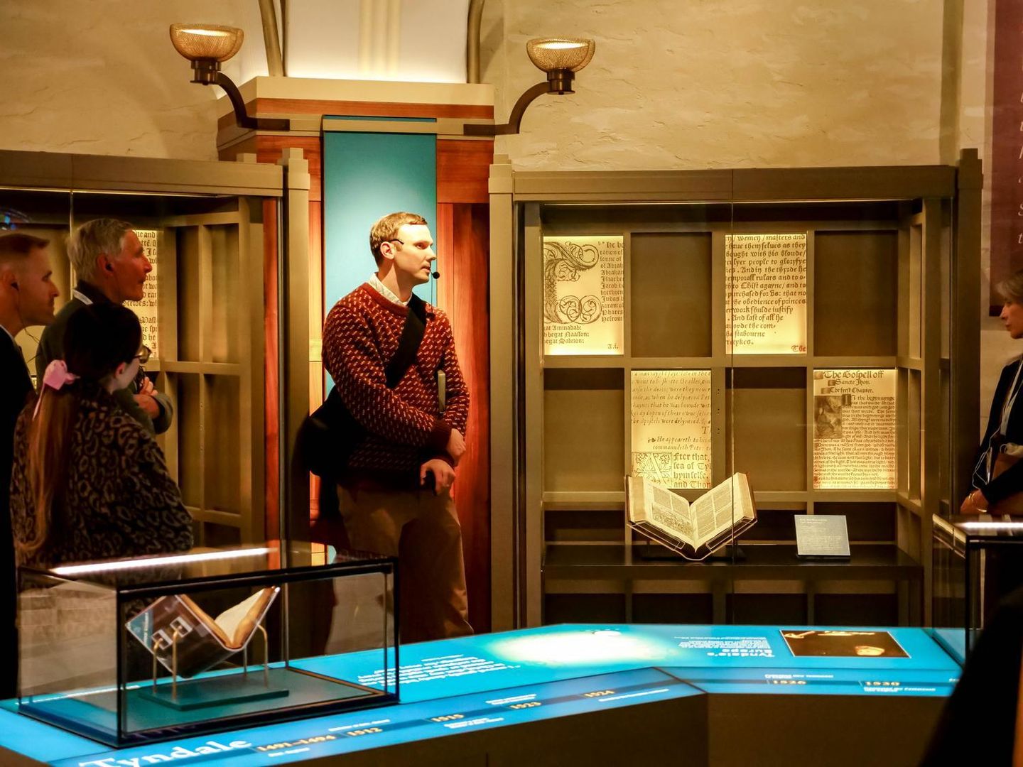 Guests examine historic Bibles in display cases at Museum of the Bible