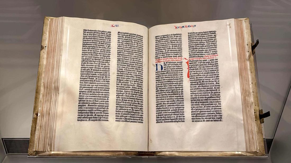 An original Gutenberg Bible, one of the first books printed with movable type, opened to the Gospel of John and displayed at the Library of Congress.