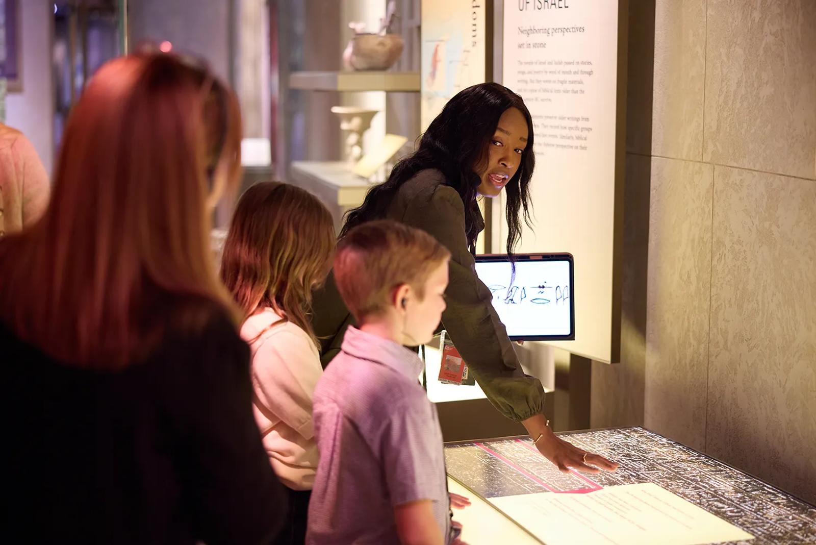 Inspire guide leads guests through an interactive exhibit at Museum of the Bible in Washington, DC.