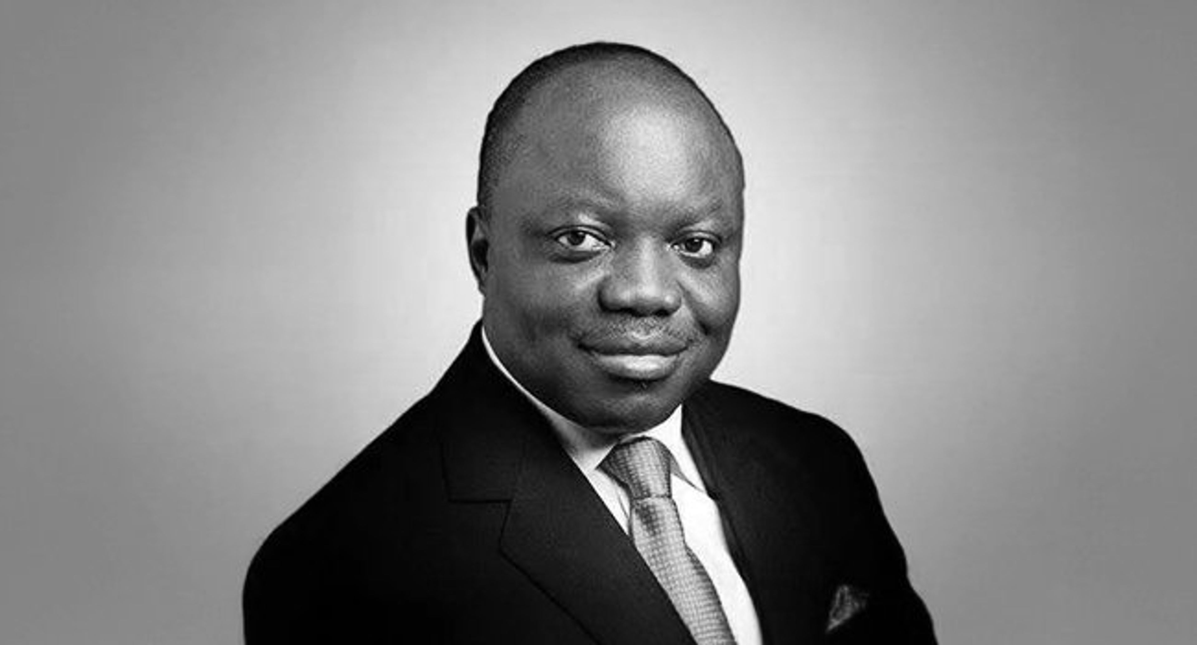 Black and white formal portrait of the former Governor of Delta State, Dr. Emmanuel Uduaghan, smiling and wearing a suit and tie.