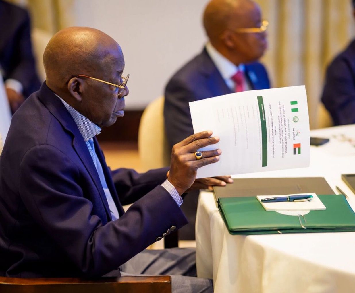 President Bola Ahmed Tinubu. reviewing an official document