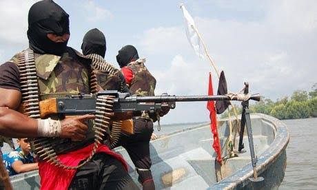 Masked armed men with ammunition belts and rifles standing in a boat on a river near mangroves