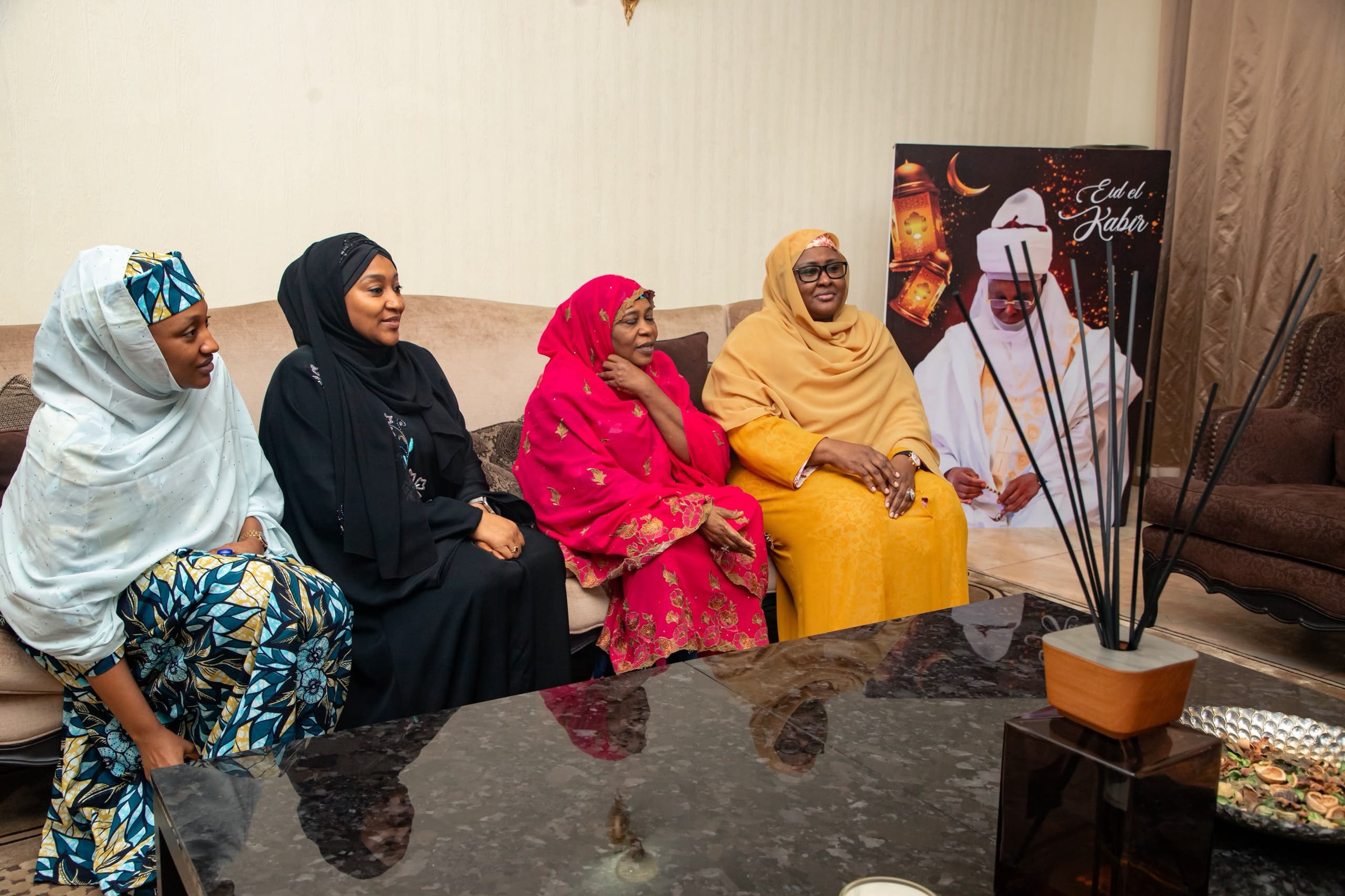 Aisha Buhari seated with several women in traditional flowing attire during a visit to Atiku Abubakar's residence in Abuja.