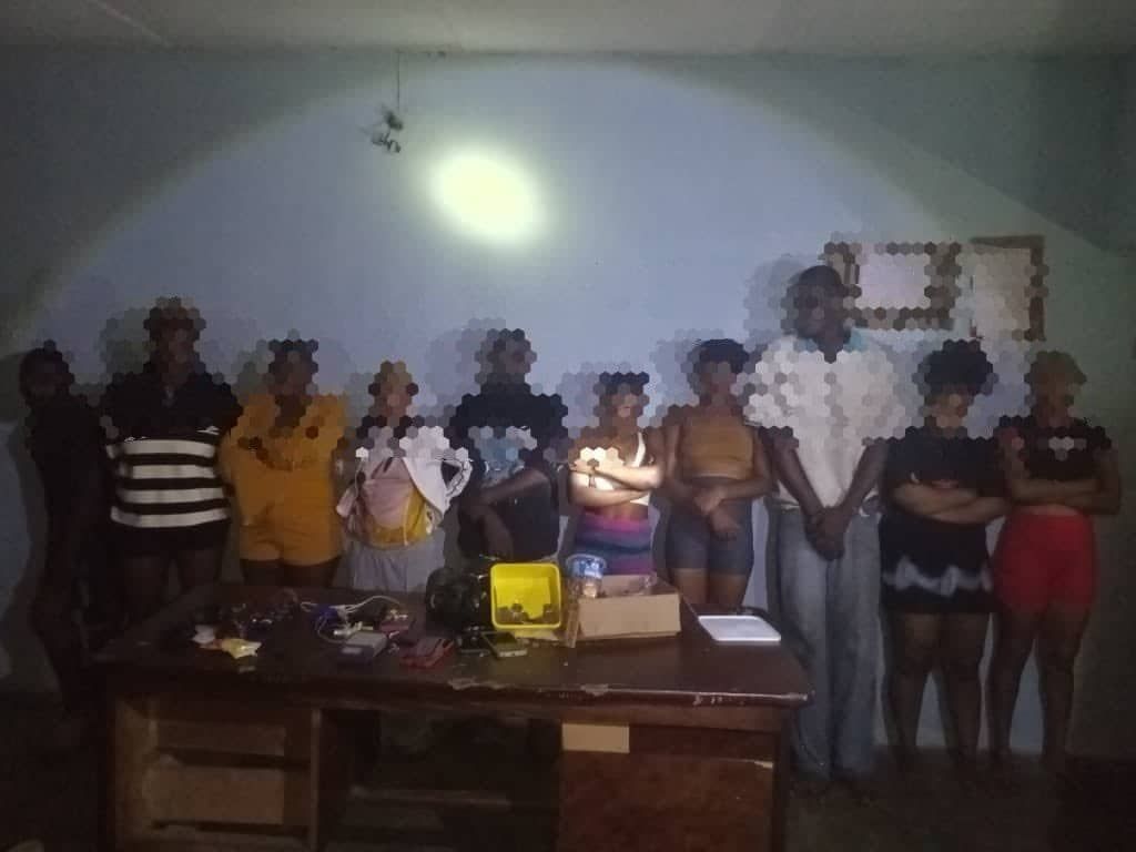 A group of suspected kidnappers standing together indoors after being apprehended by security operatives following the rescue operation near Agbor