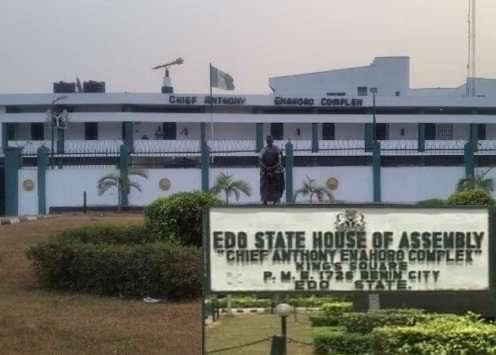 Signboard for the Edo State House of Assembly in front of the white legislative complex and flagpole