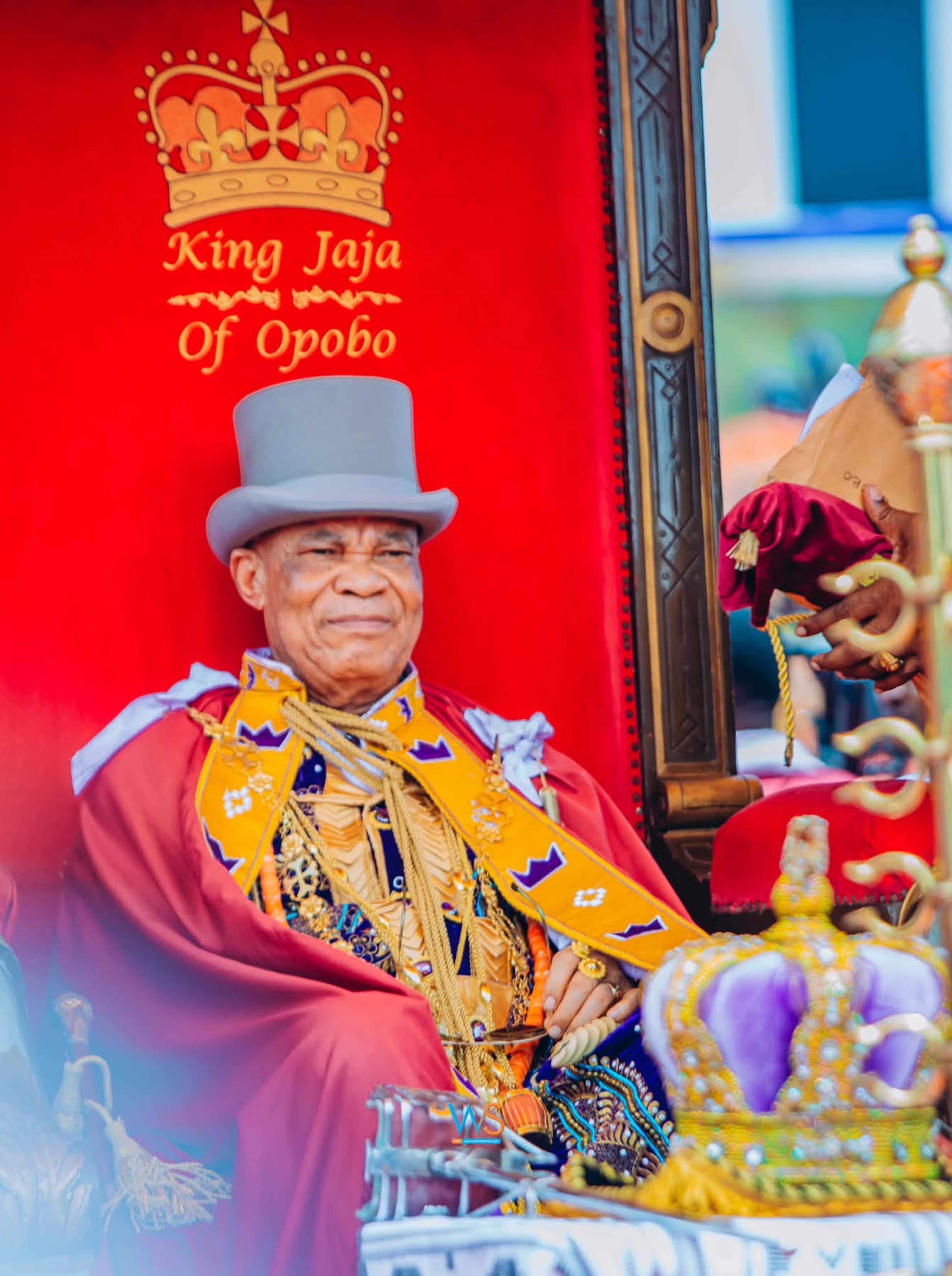 King Jaja VI seated in full royal regalia during his coronation ceremony.