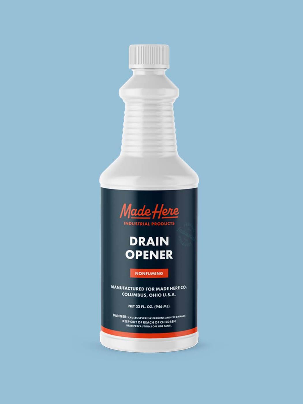 A bottle of Made Here industrial cleaner on a light blue background