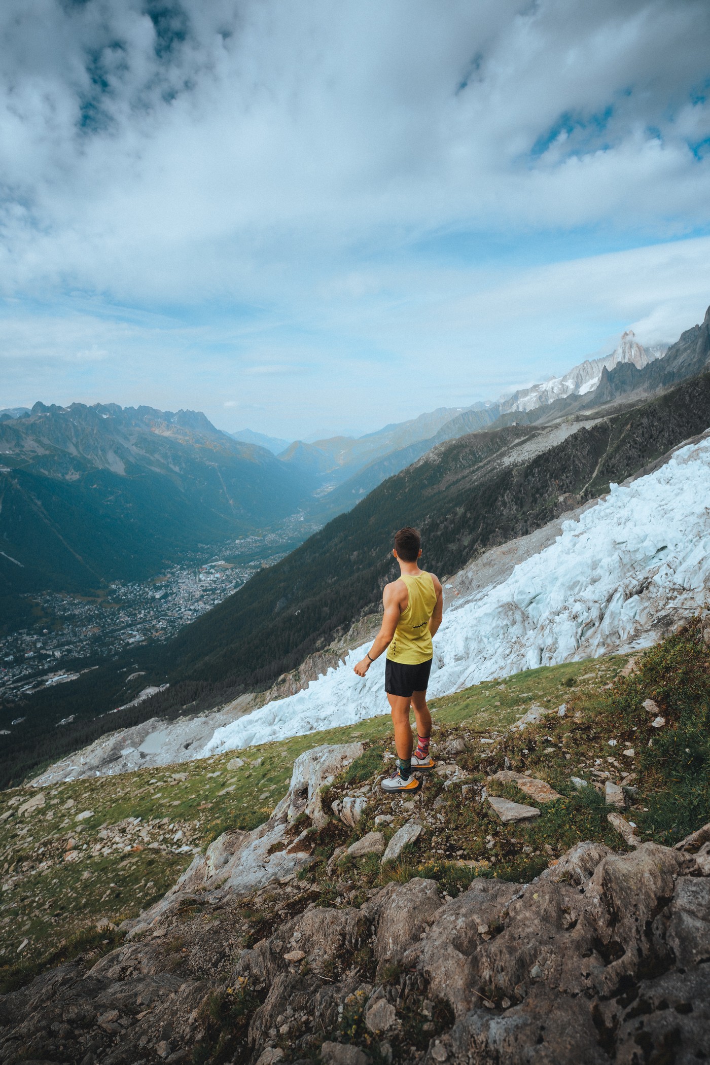 A person looks out at the town of Chamonix from high on the mountain.