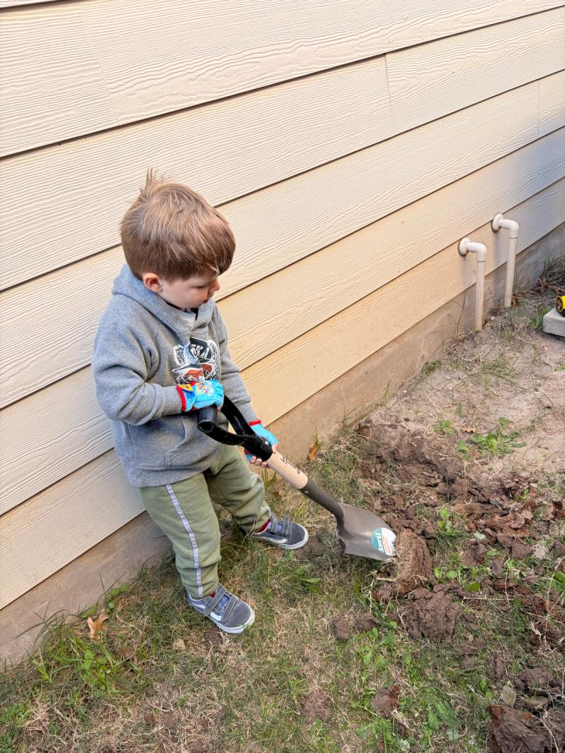 Elias helping me dig out the area for the pad