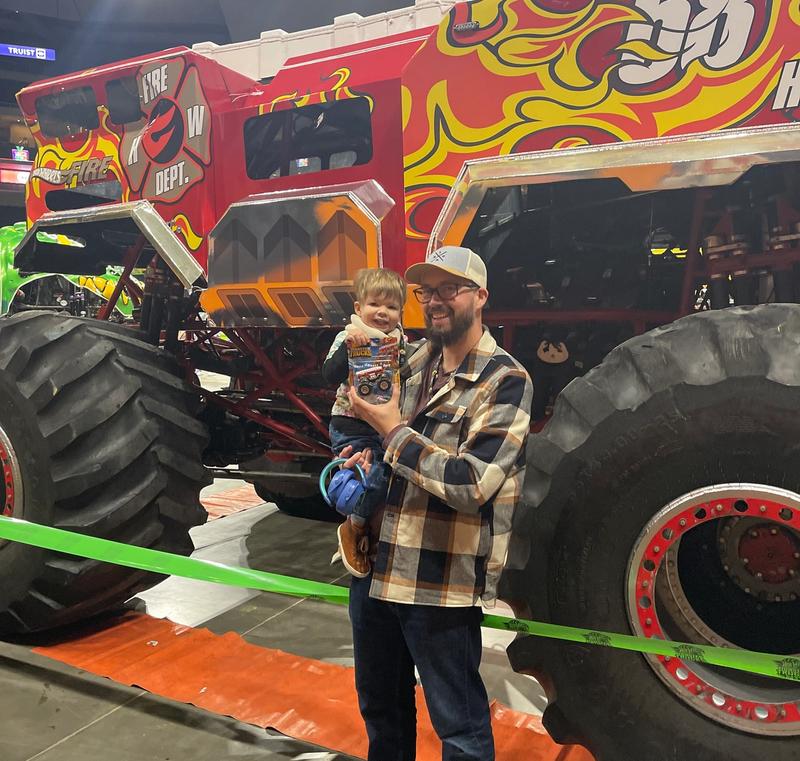 Elias and I in front of 5 Alarm at Hot Wheels Monster Trucks Live