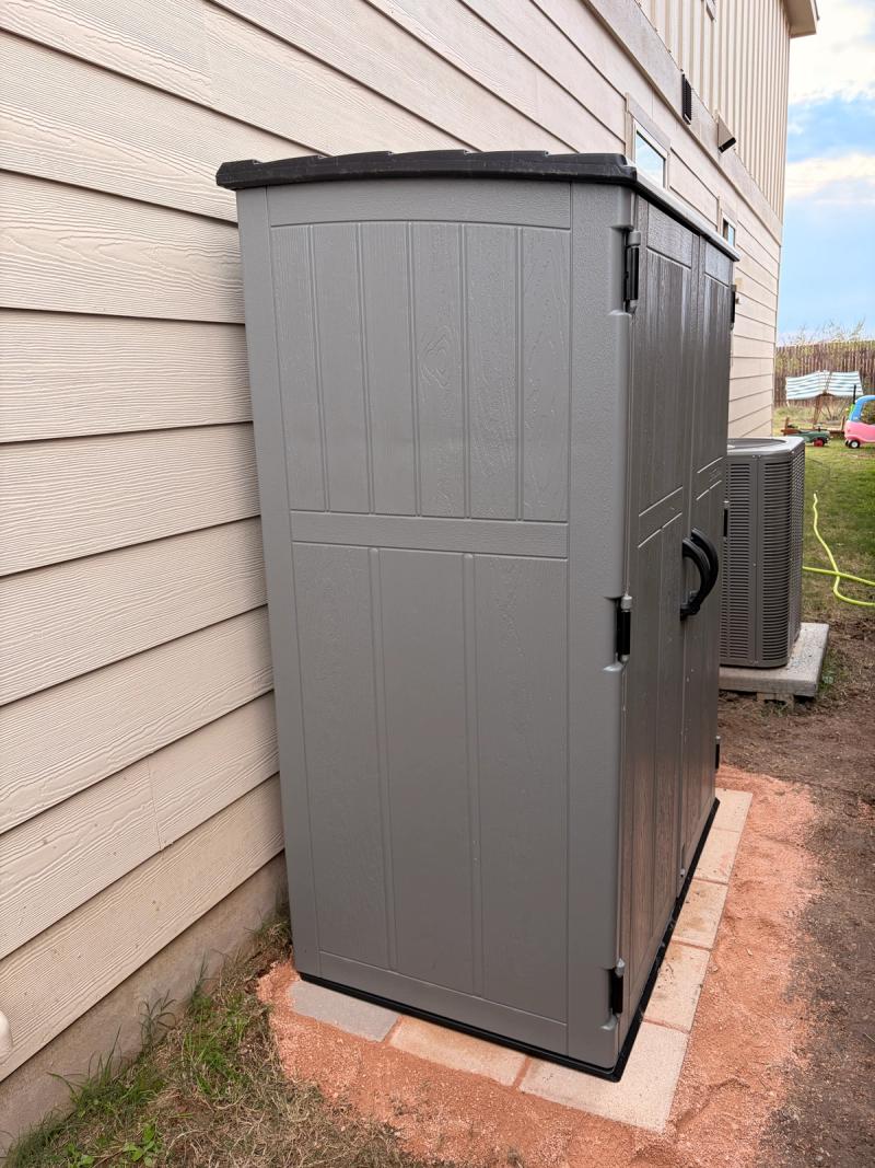 The finished shed sitting next to our house on top of the pad I made out of pavers