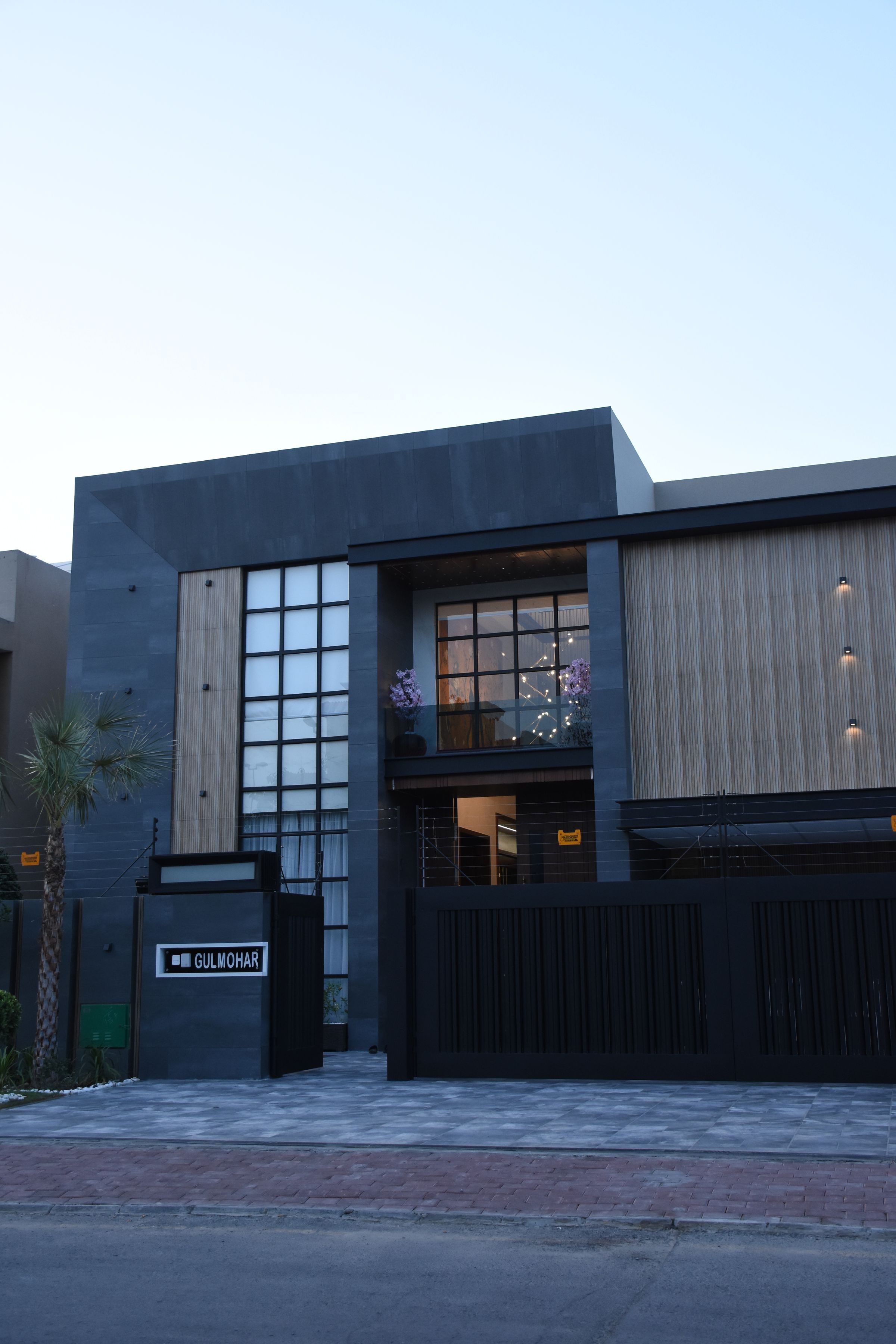 A contemporary house in Lahore with glass and wood on the facade