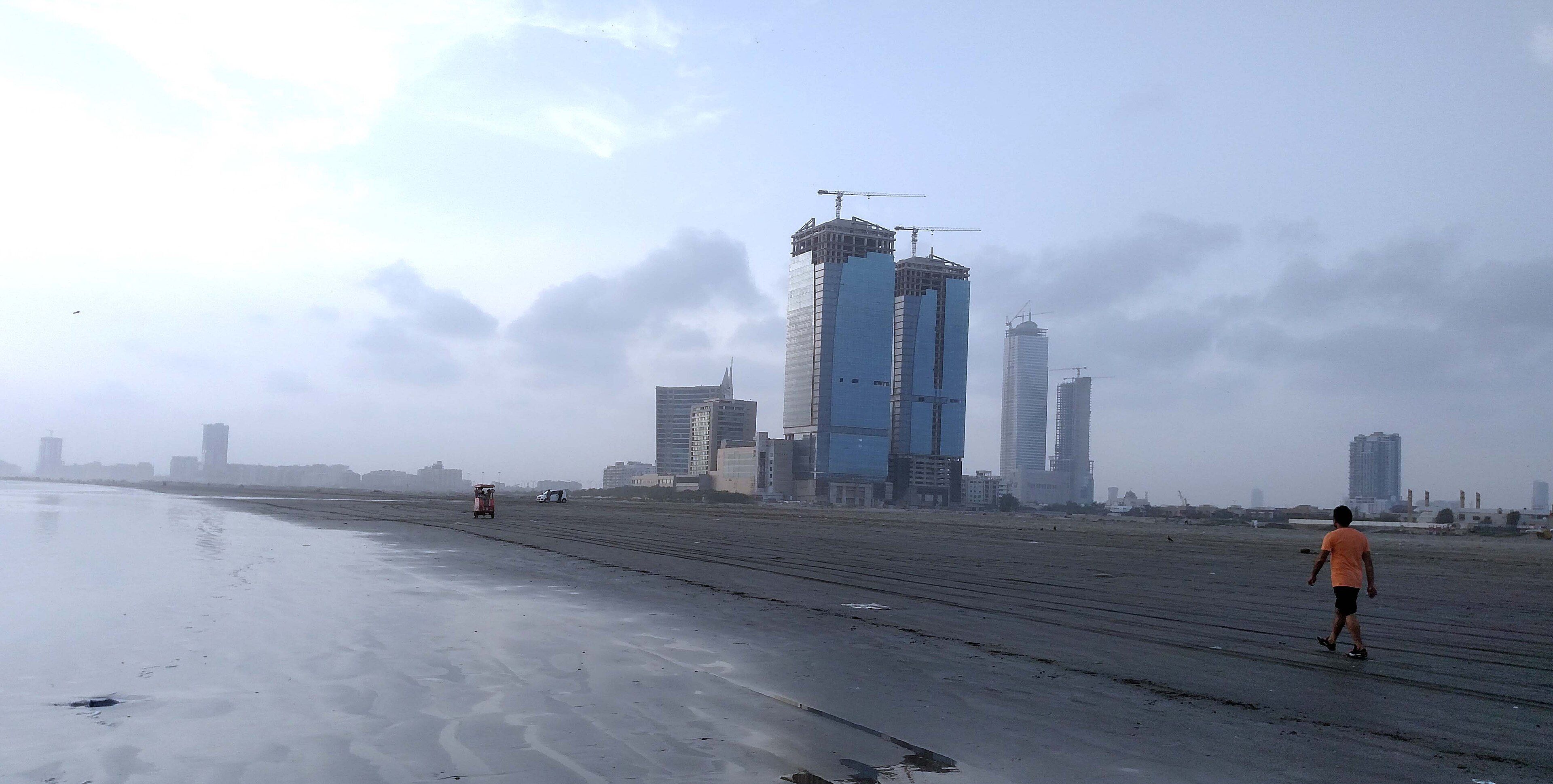 High-rise towers under construction behind Clifton Beach, Karachi
