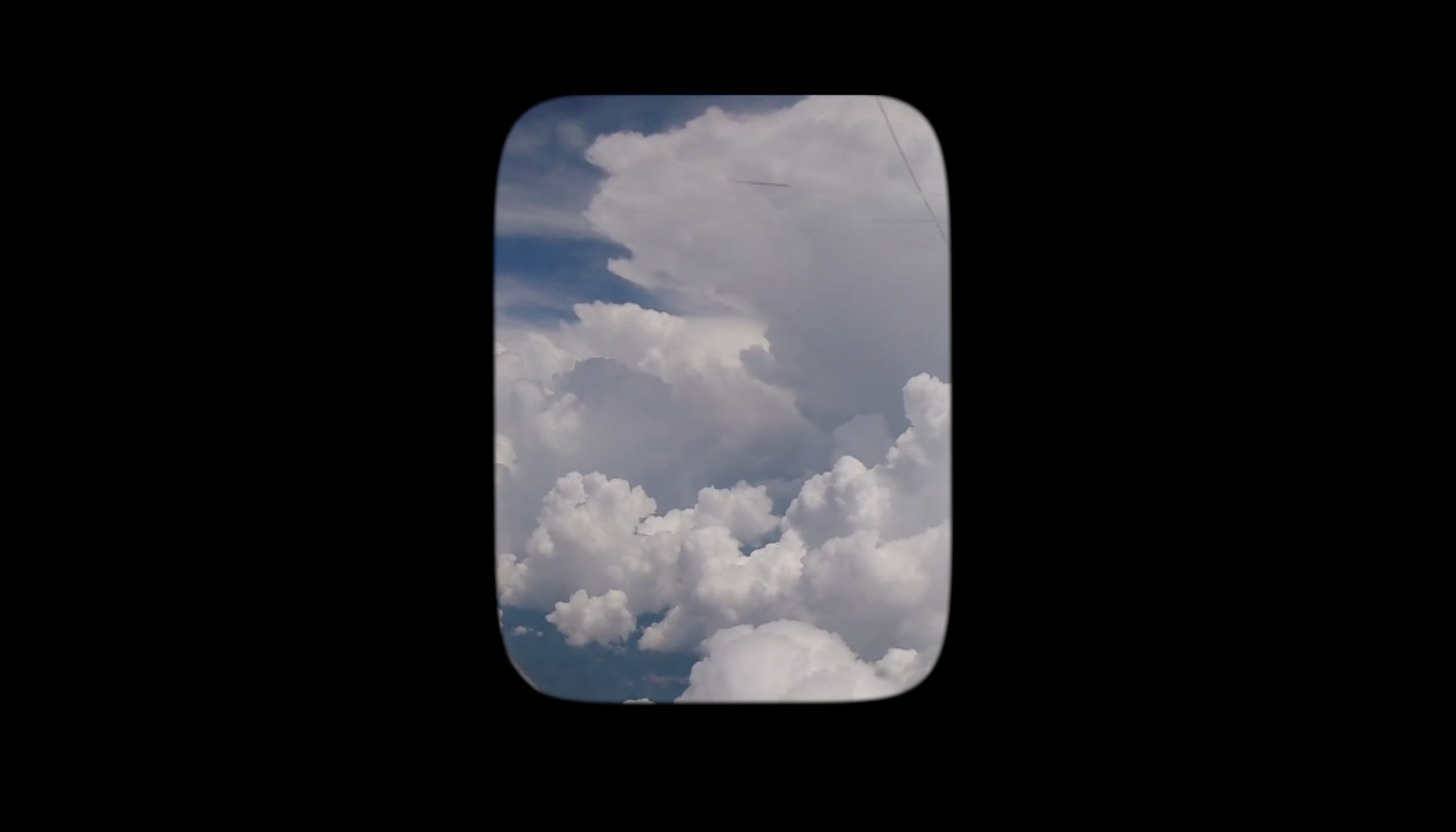 Sky is visible through an airplane window