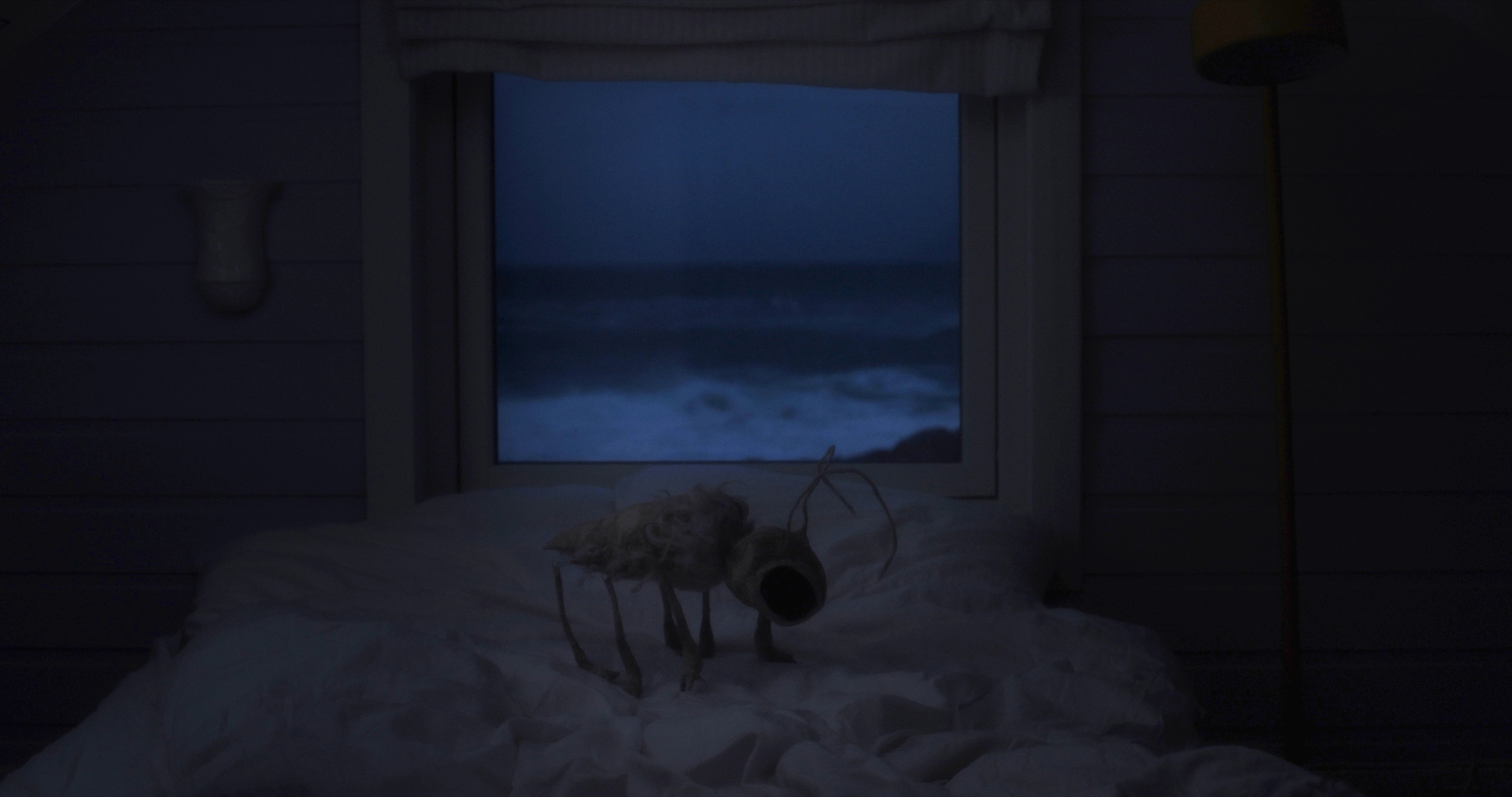 An insect stands in a bed, in front of a window to a stormy seascape.