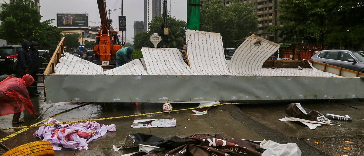 People wading through flooded streets in Mumbai