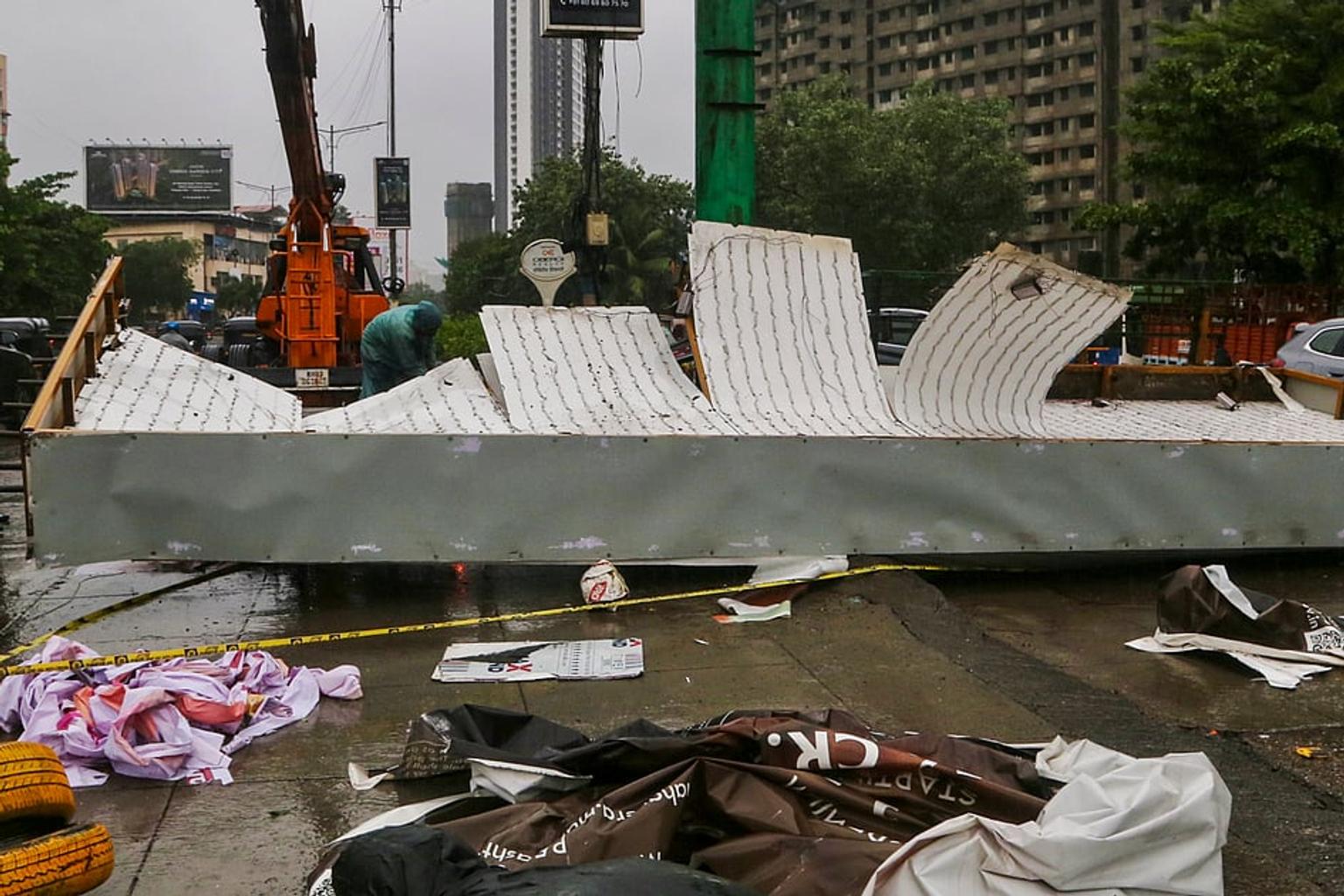 People wading through flooded streets in Mumbai