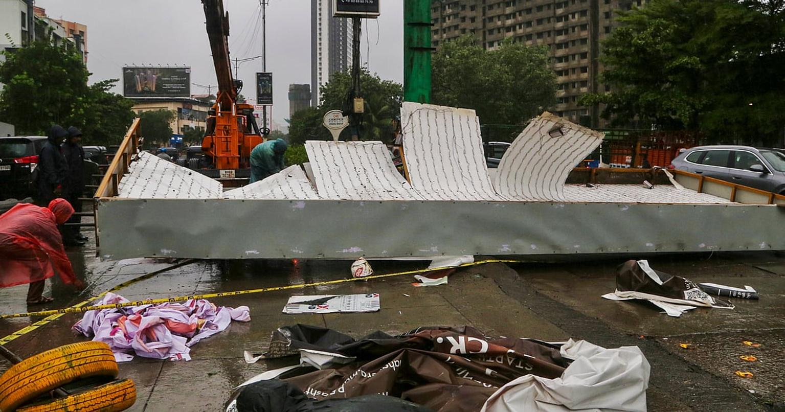 People wading through flooded streets in Mumbai