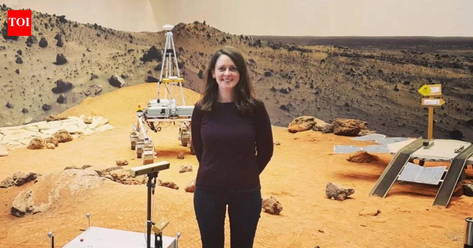 Claire Parfitt in a space suit with a Mars landscape background