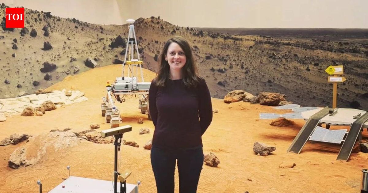 Claire Parfitt in a space suit with a Mars landscape background