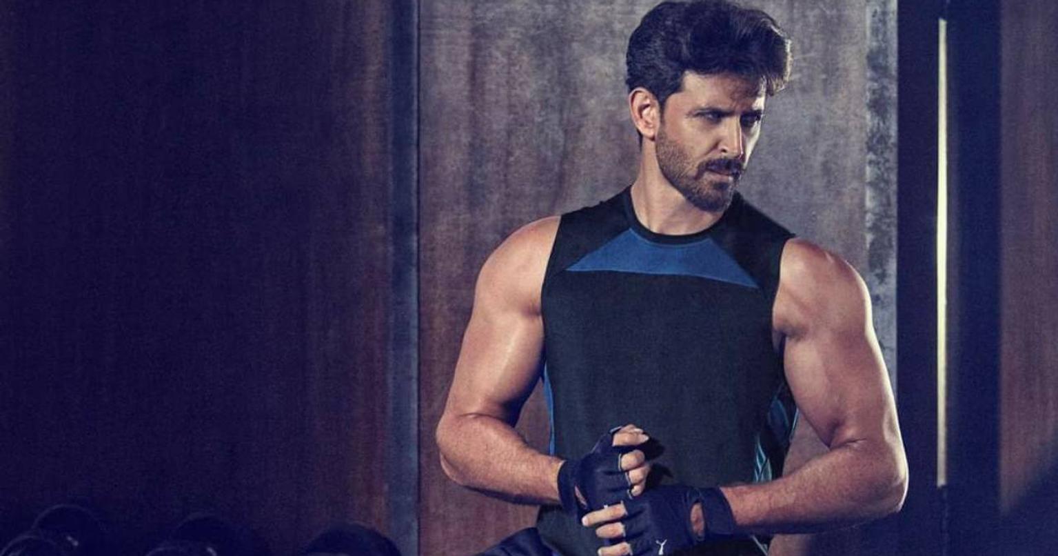 Hrithik Roshan posing with Cult.fit logo and fitness equipment