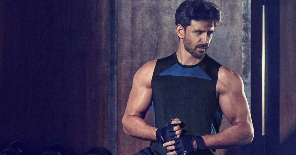 Hrithik Roshan posing with Cult.fit logo and fitness equipment