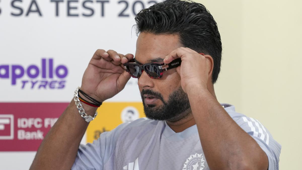 Rishabh Pant standing in front of Uttarakhand landscape with mountains