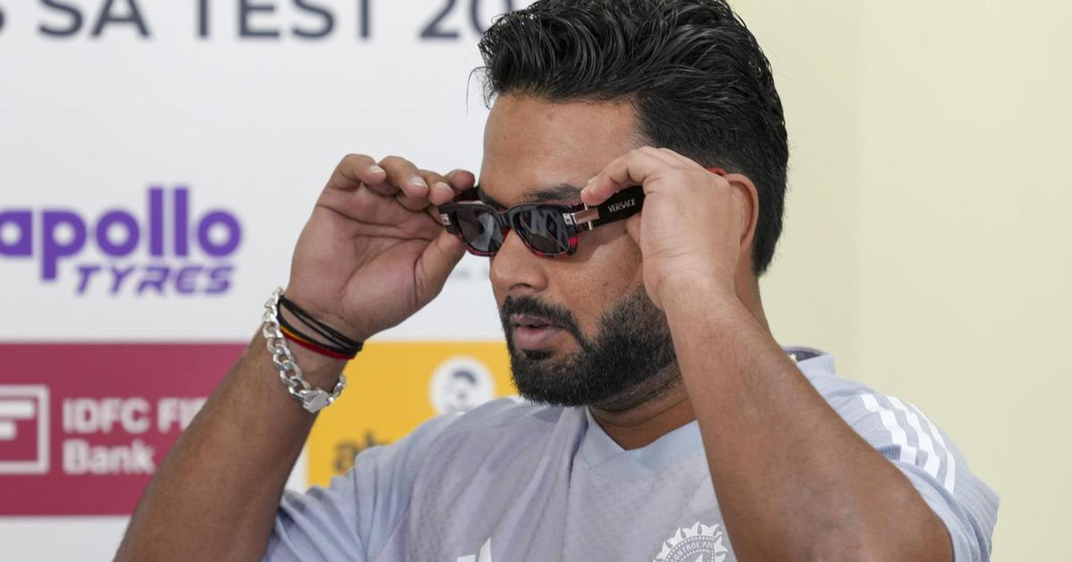 Rishabh Pant standing in front of Uttarakhand landscape with mountains