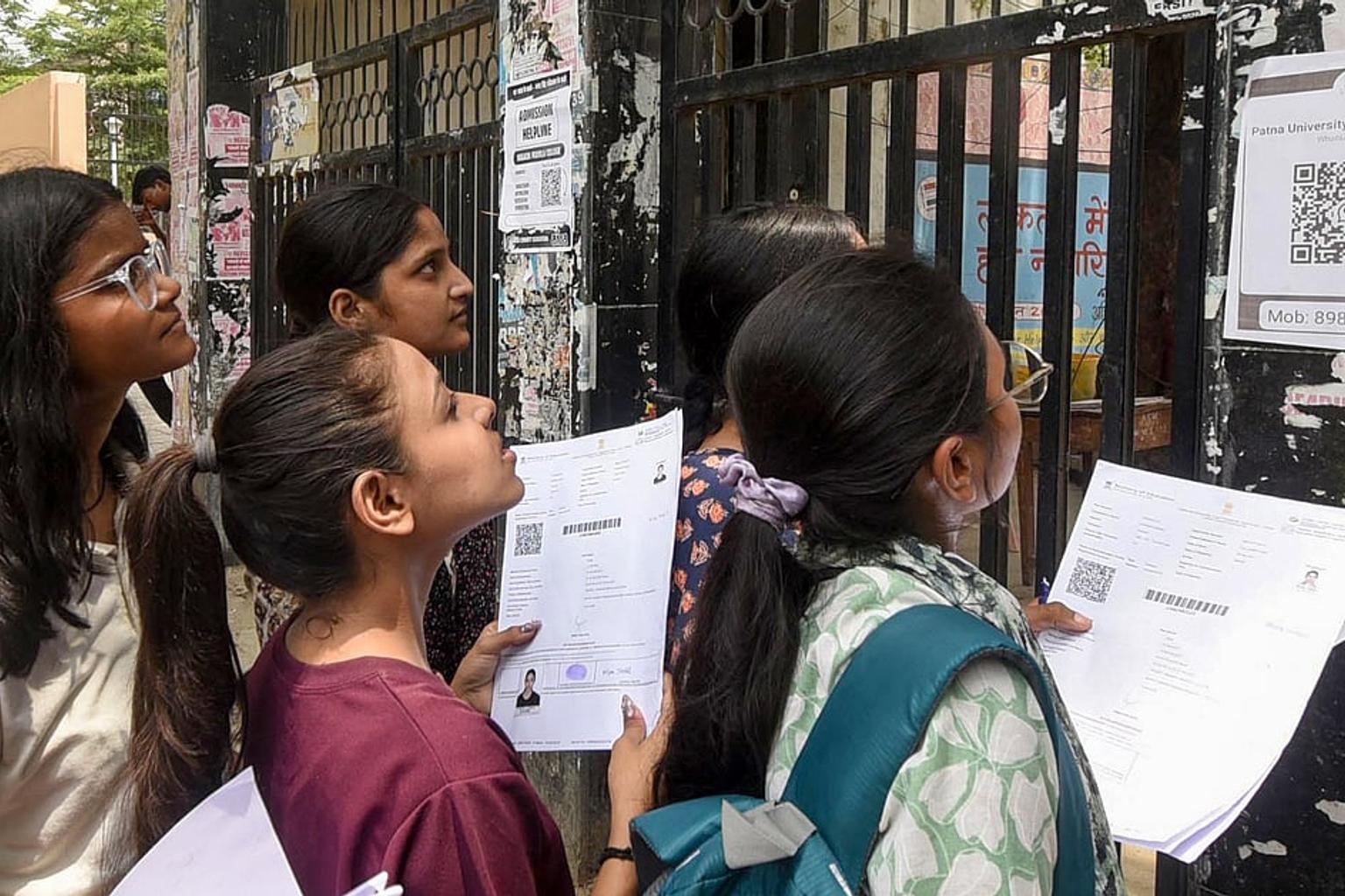Students checking NEET UG 2026 results on their mobile phones