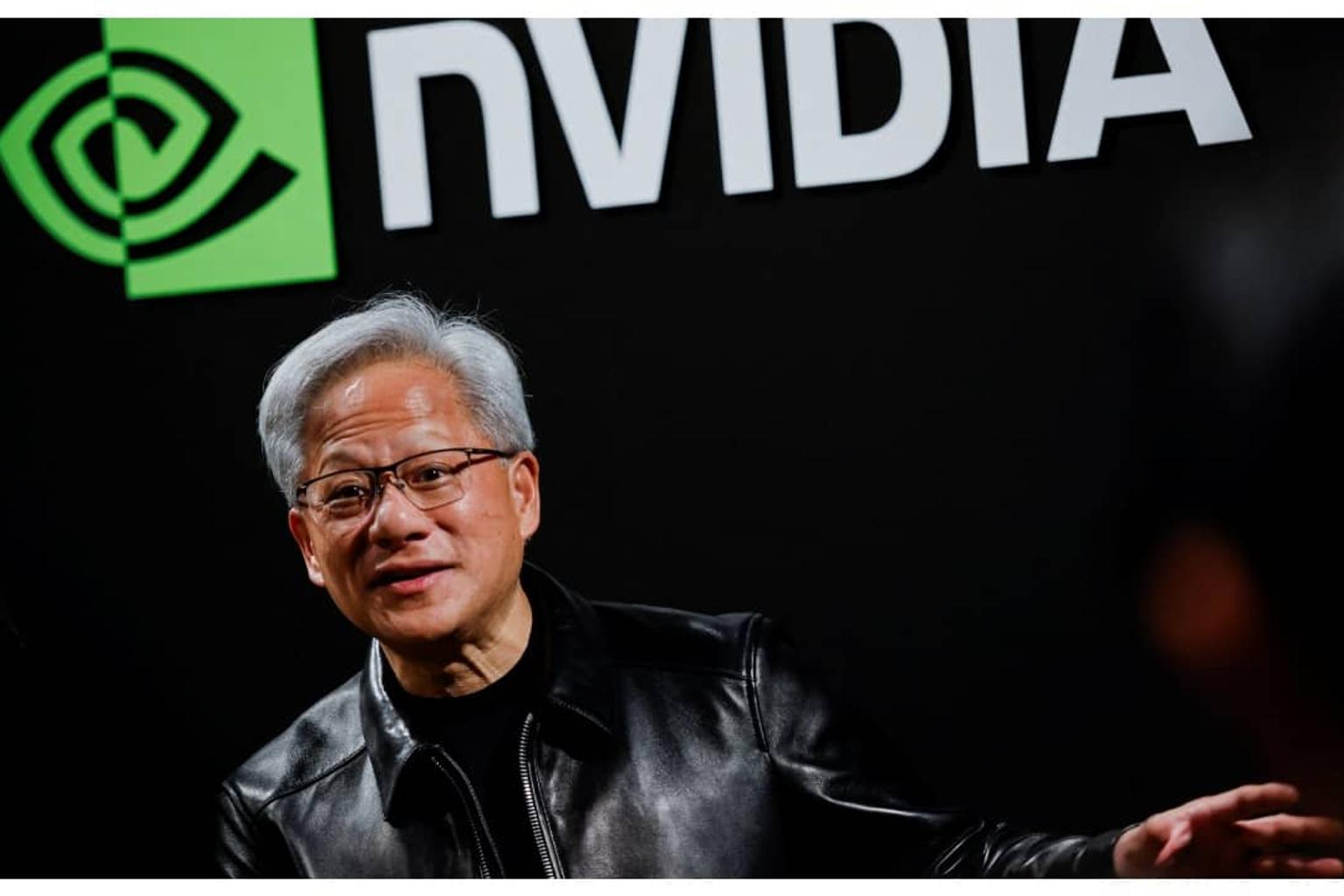 Nvidia and SK Group executives shaking hands at a press conference