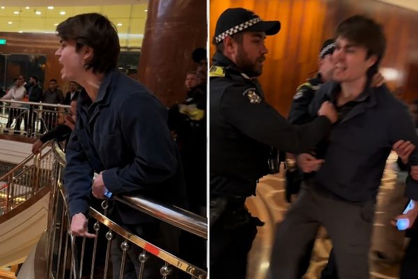Protester outside PM Modi's hotel in Melbourne, Australia, with security personnel