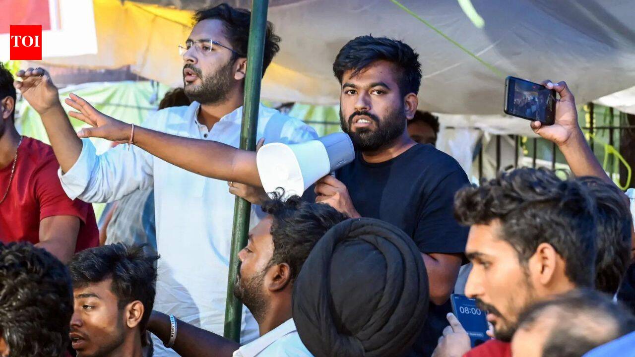 Security personnel with tear gas gun at protest site