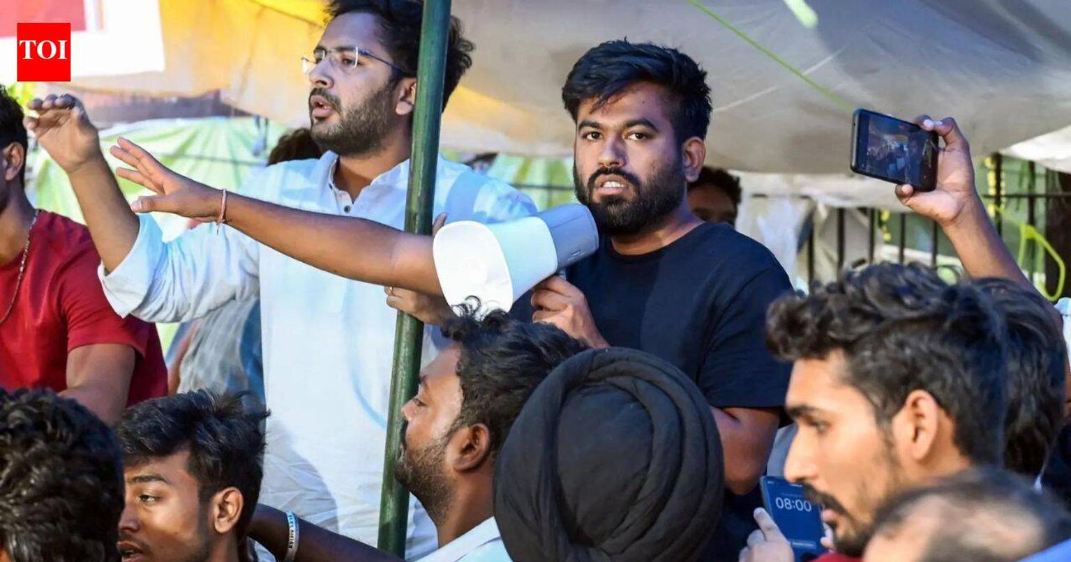 Security personnel with tear gas gun at protest site