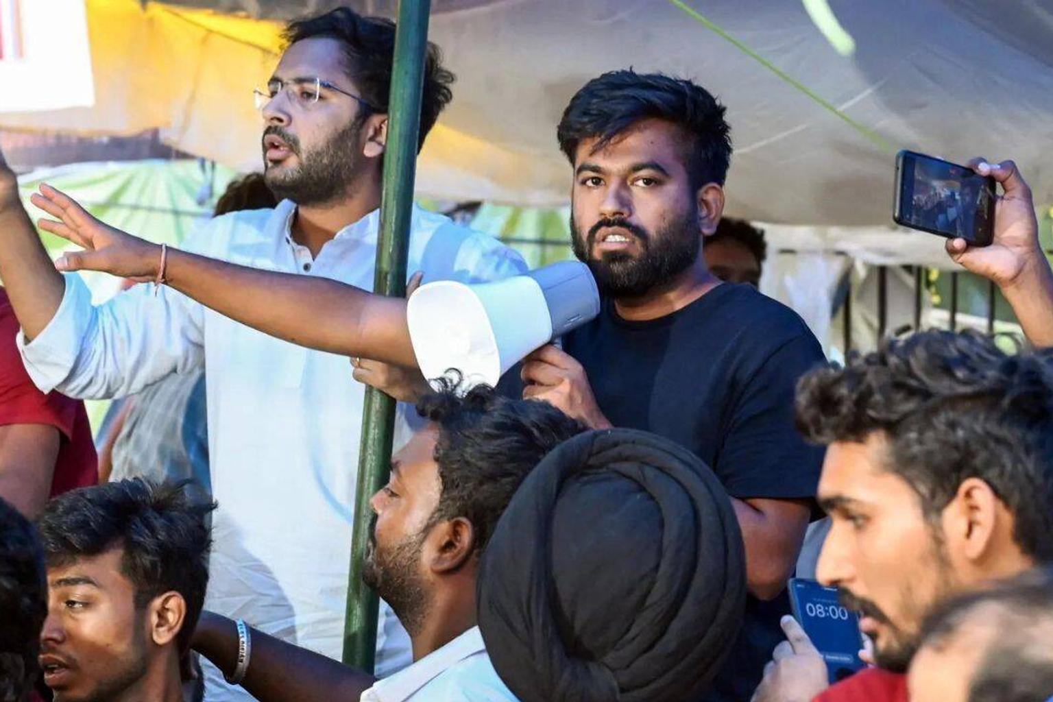 Security personnel with tear gas gun at protest site