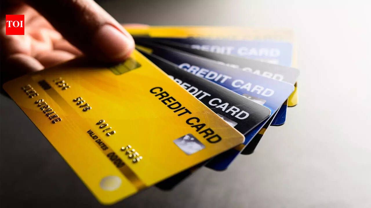 Person holding a credit card and using a laptop
