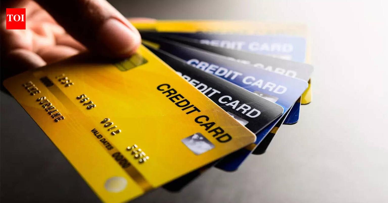 Person holding a credit card and using a laptop